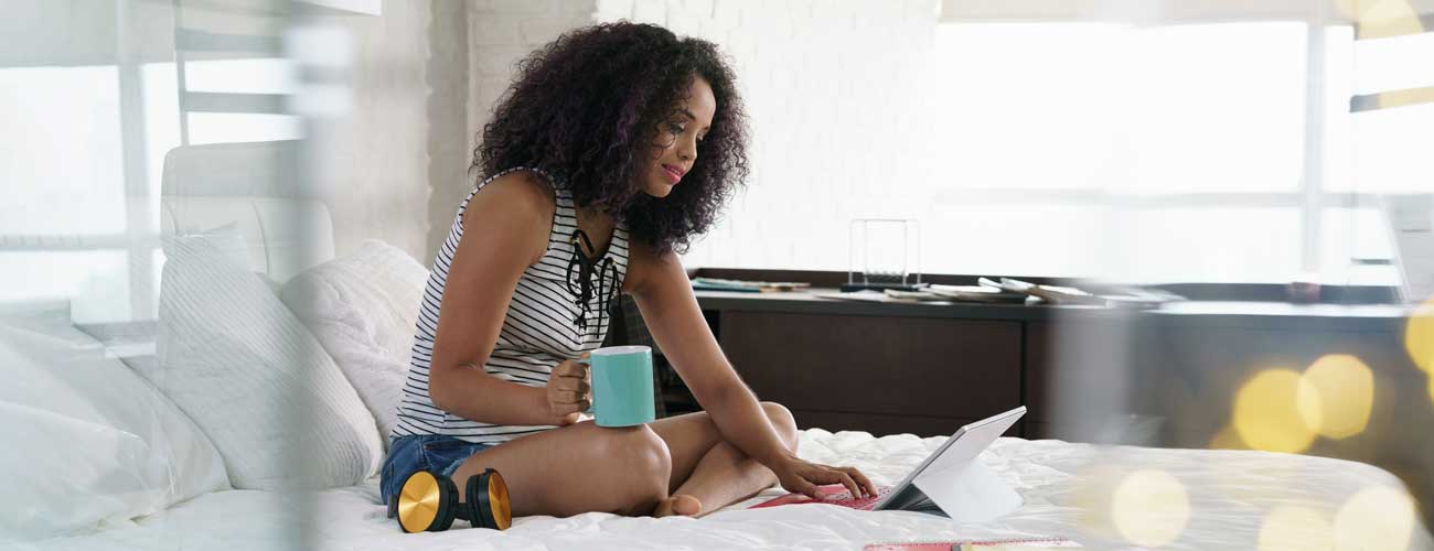 Woman in a dorm room on bed