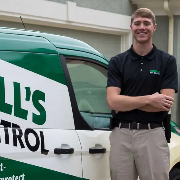 Exterminator standing in front of working van | Russell's Pest Control serving Knoxville, TN